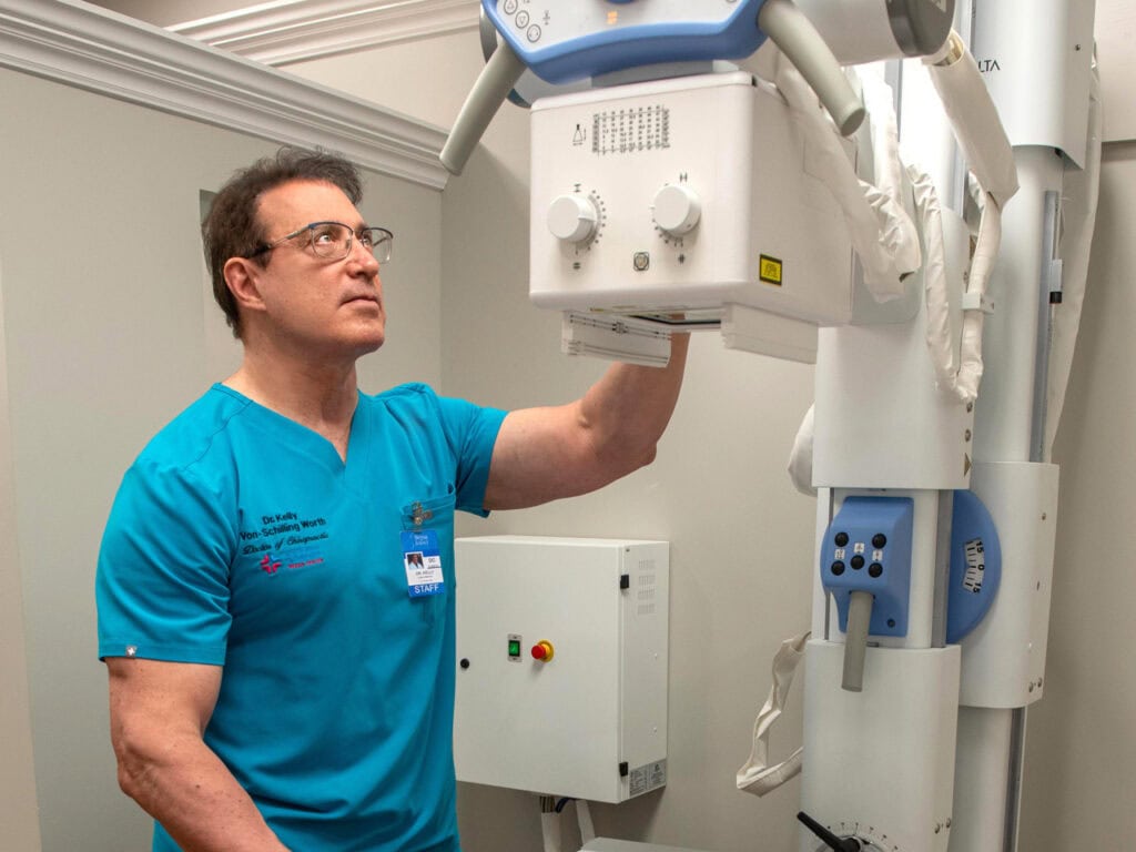 Dr. Kelly working on an x-ray machine