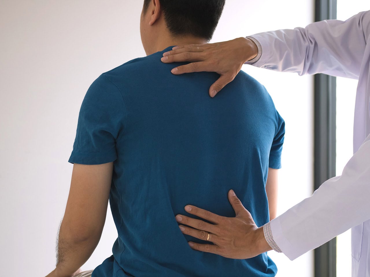 back injury exam in doctor office