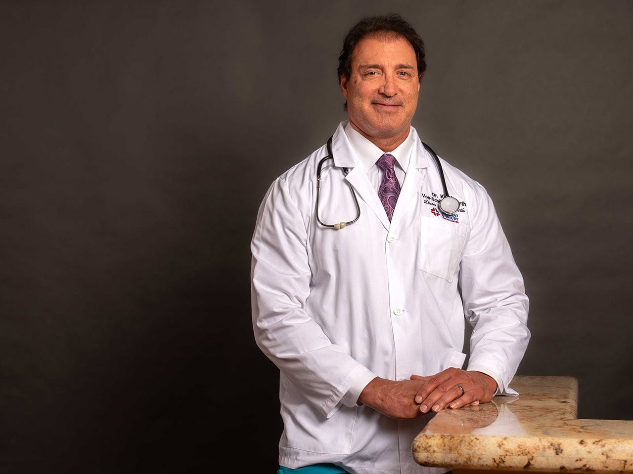 Dr kelly standing by desk