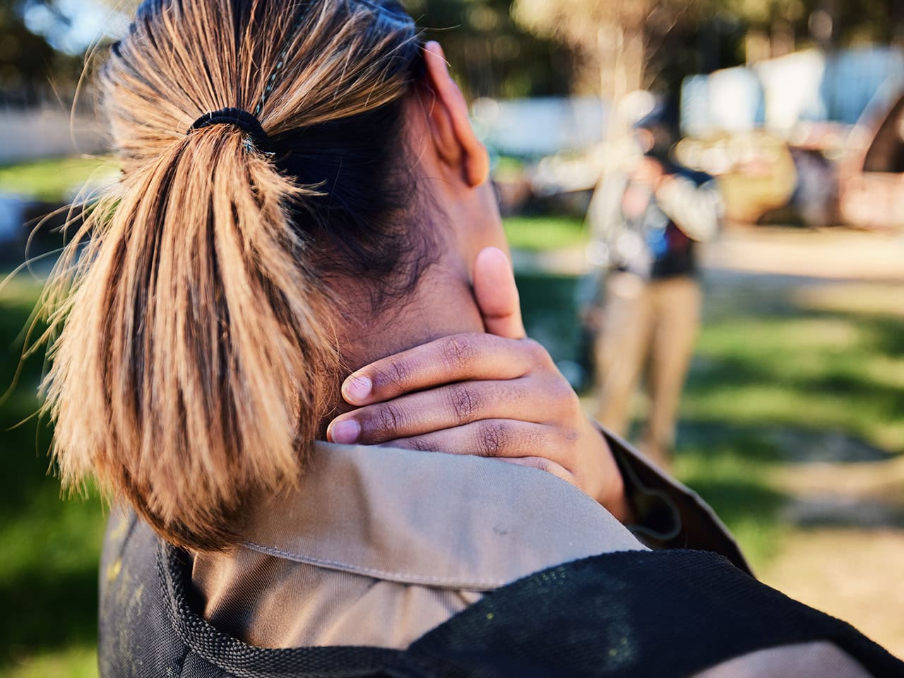 woman holding her neck in pain
